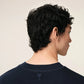 Navy blue t-shirt with 'ami' logo on a beige background ami paris