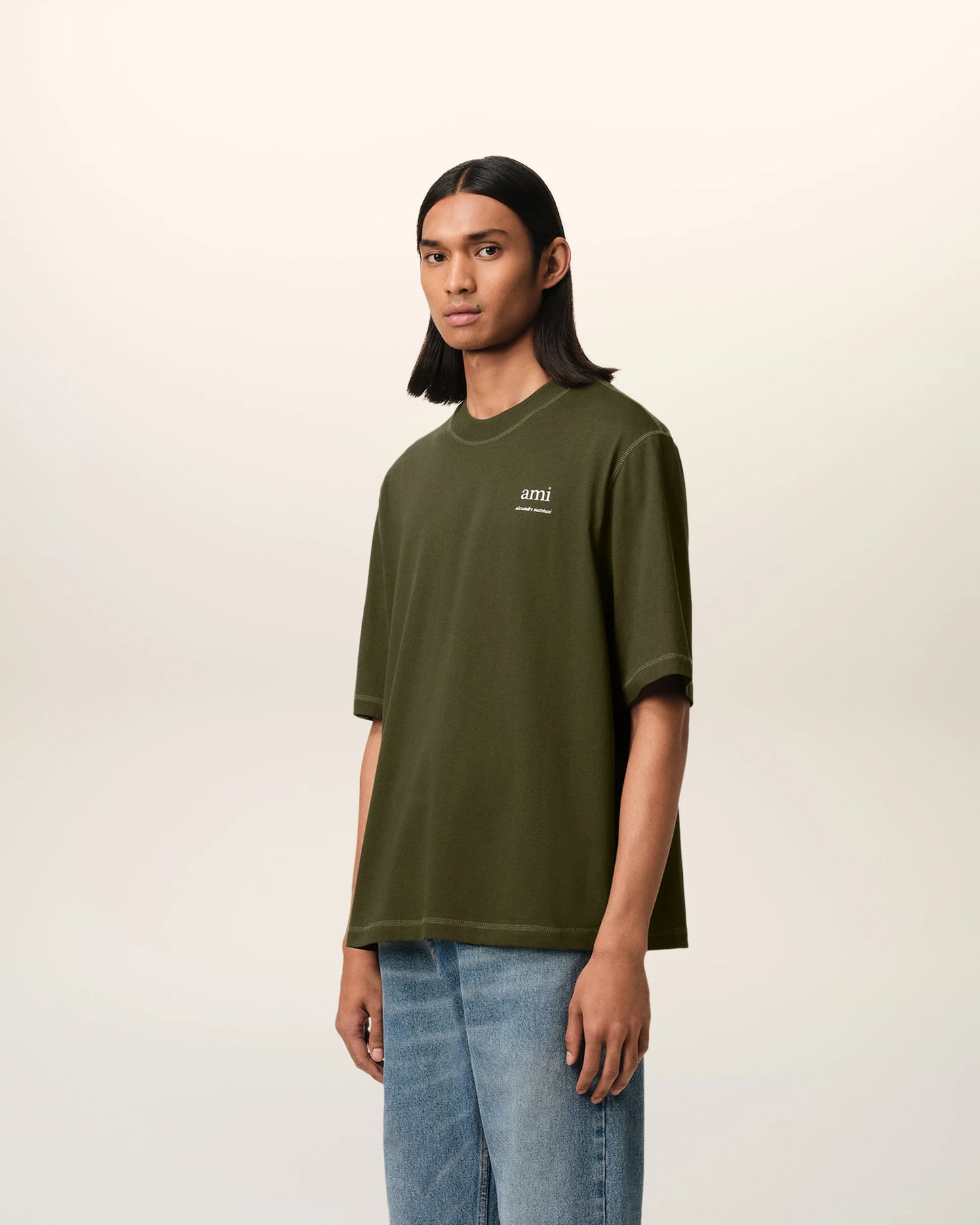 Green t-shirt with a small logo on a white background ami paris