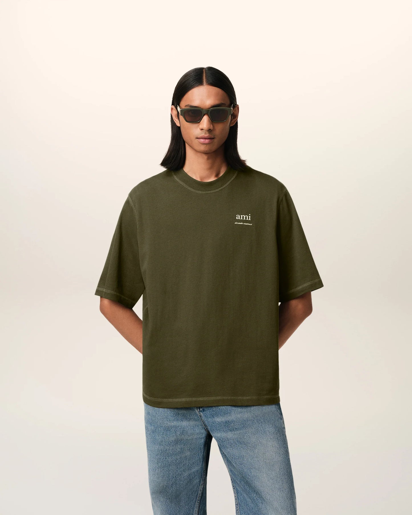 Green t-shirt with a small logo on a white background ami paris