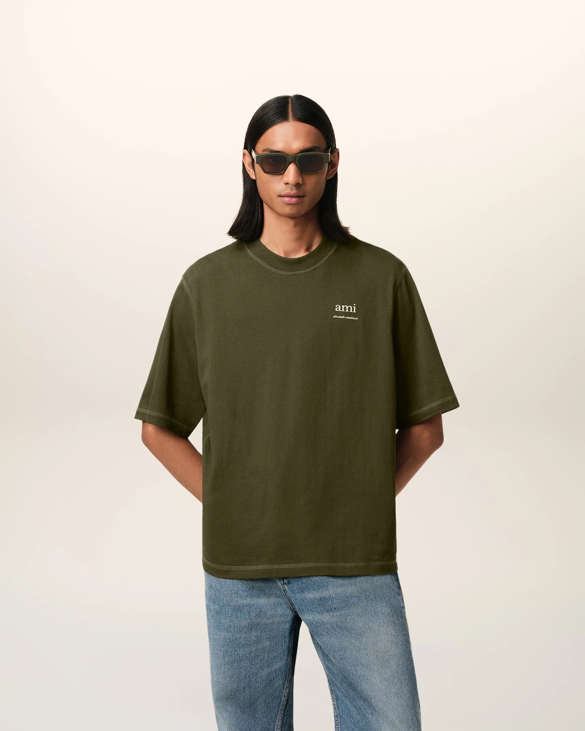 Green t-shirt with a small logo on a white background ami paris