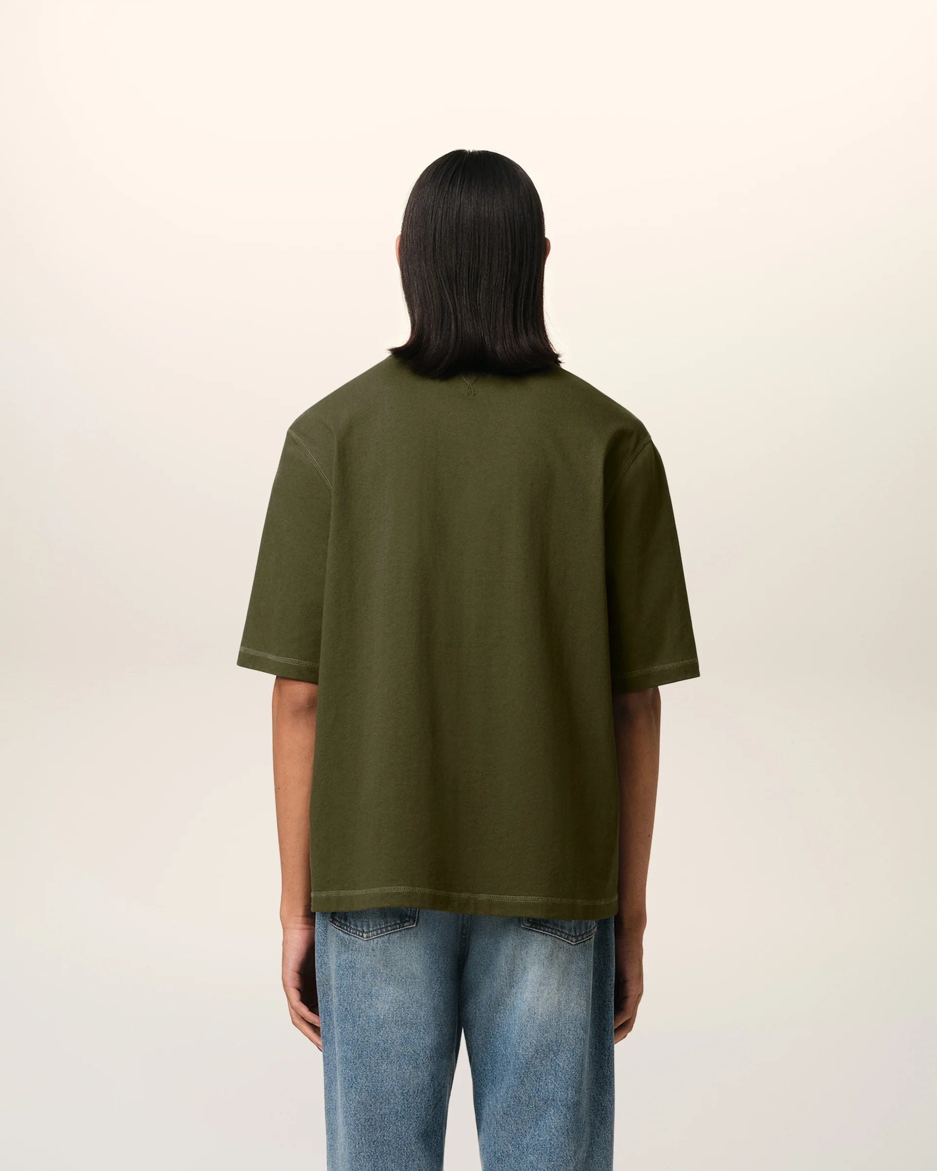 Green t-shirt with a small logo on a white background ami paris