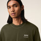 Green t-shirt with a small logo on a white background ami paris