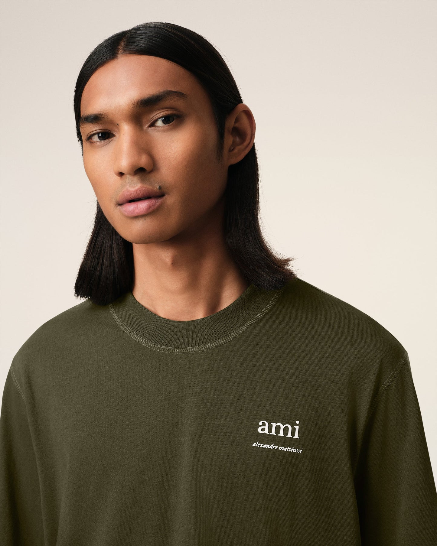 Green t-shirt with a small logo on a white background ami paris