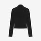 Black long-sleeve top on a light gray background