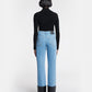 Person wearing light blue jeans with black cuffs on a white background