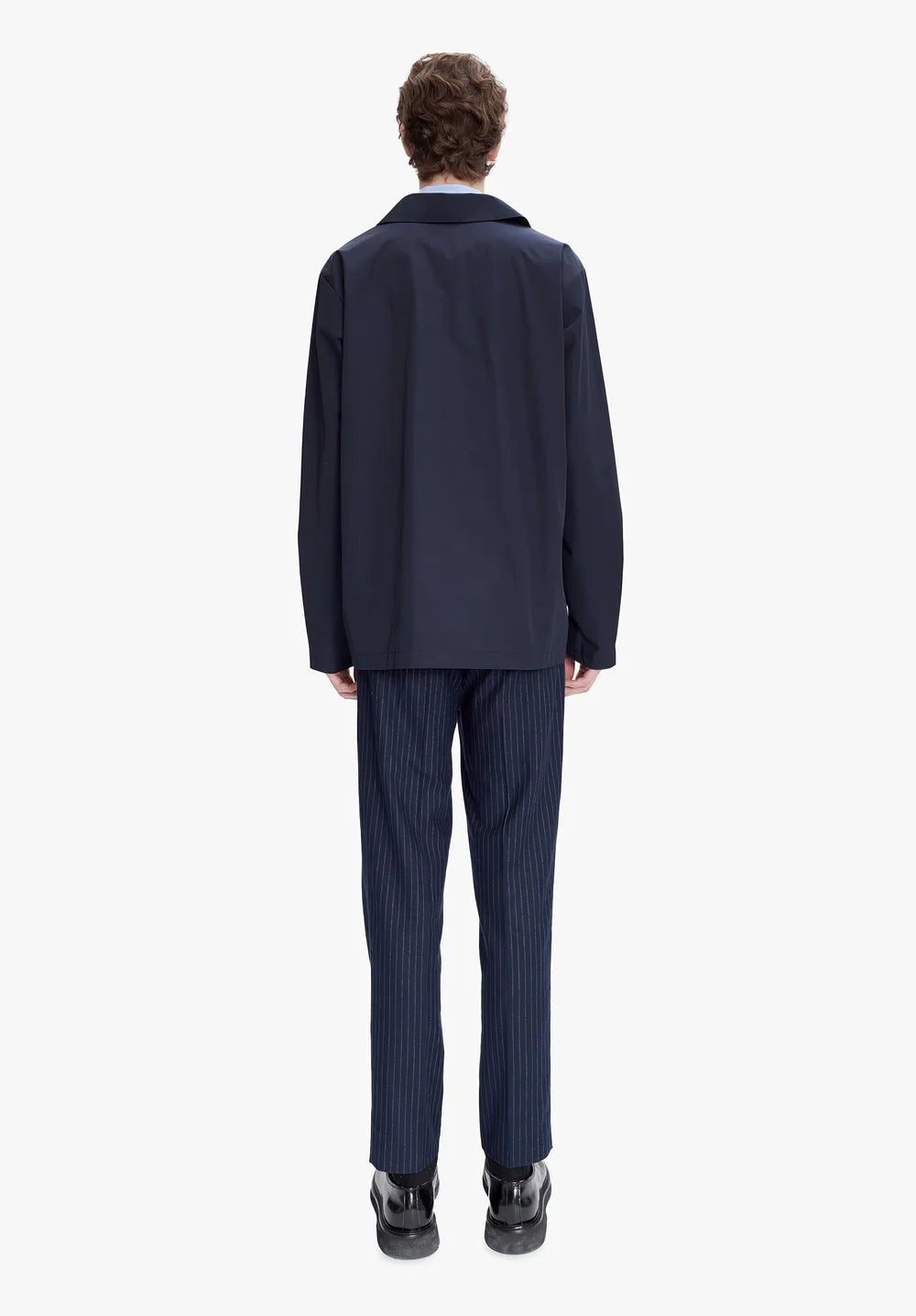 Navy blue shirt with a brand logo on a light gray background
