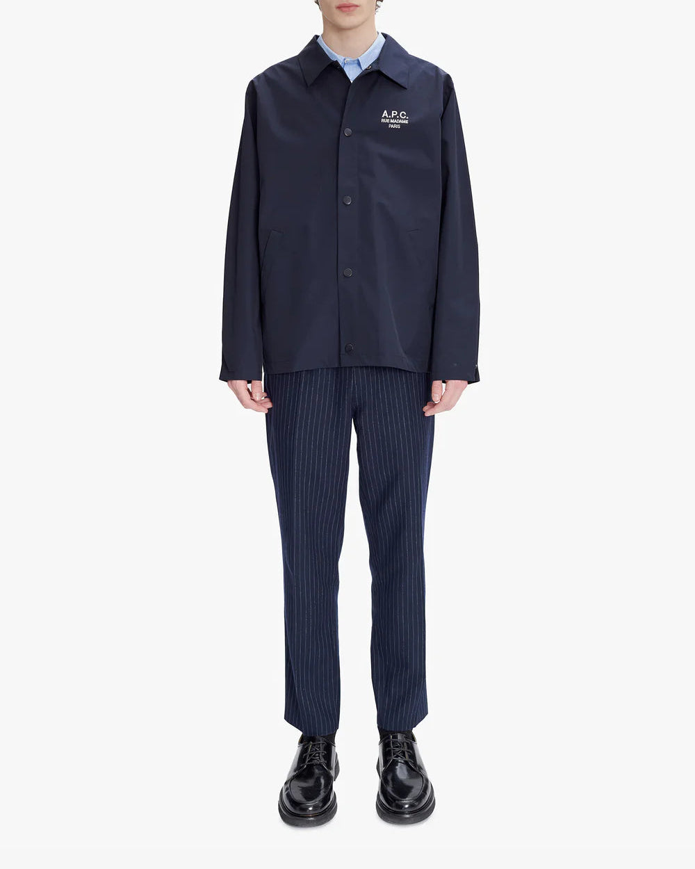 Navy blue shirt with a brand logo on a light gray background