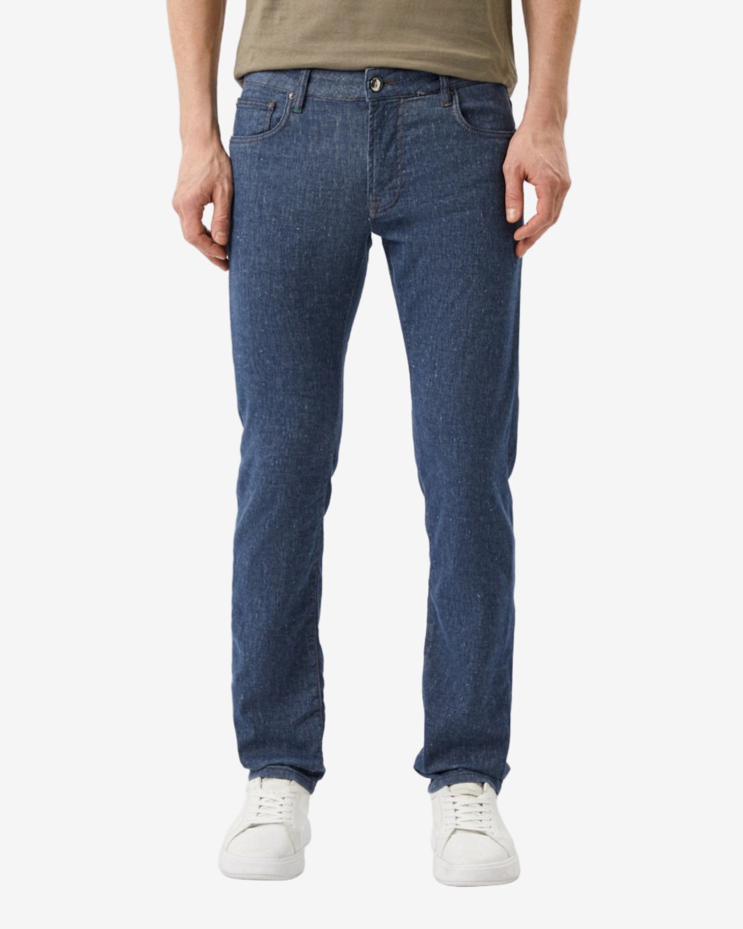 Person wearing blue jeans and a green shirt on a white background