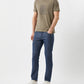 Man wearing a green t-shirt and blue jeans on a white background