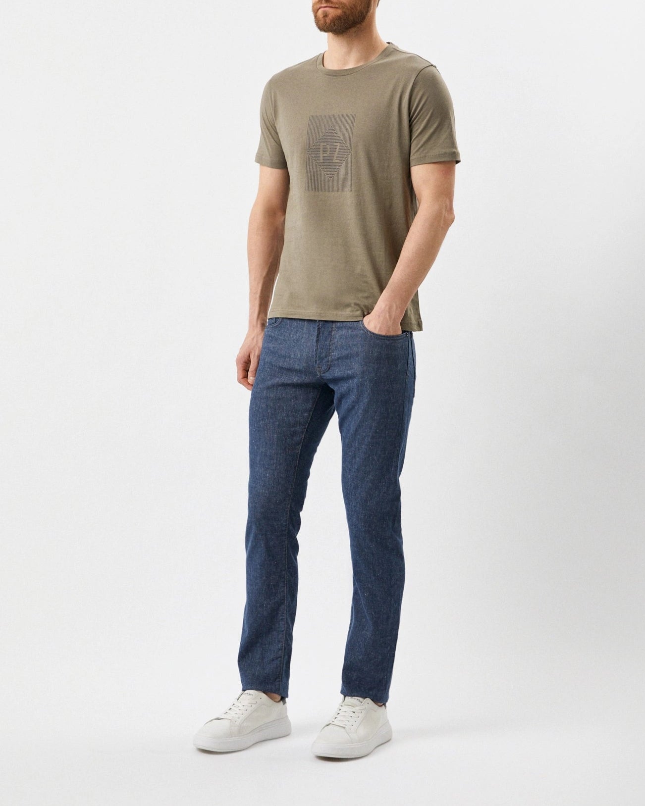 Man wearing a green t-shirt and blue jeans on a white background