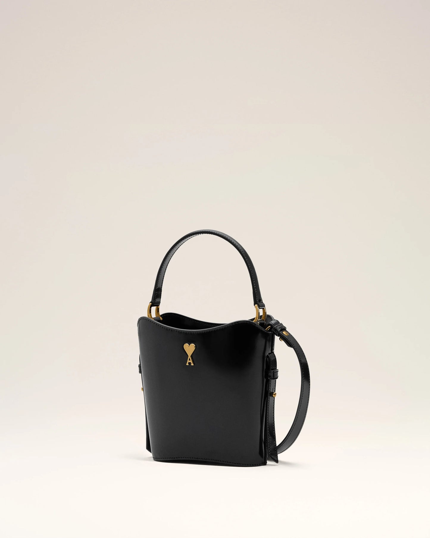 Black drawstring bag with a heart-shaped key emblem on a white background