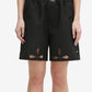 Black shorts with cut-out designs on a white background