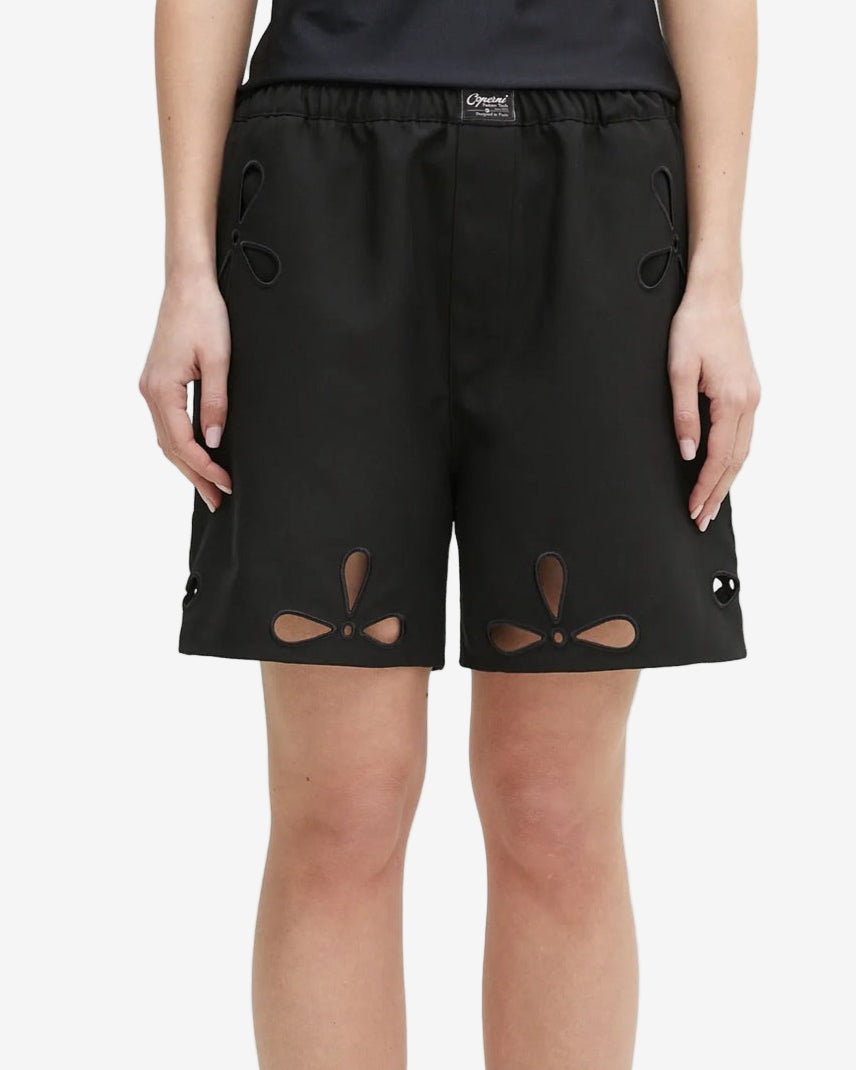 Black shorts with cut-out designs on a white background