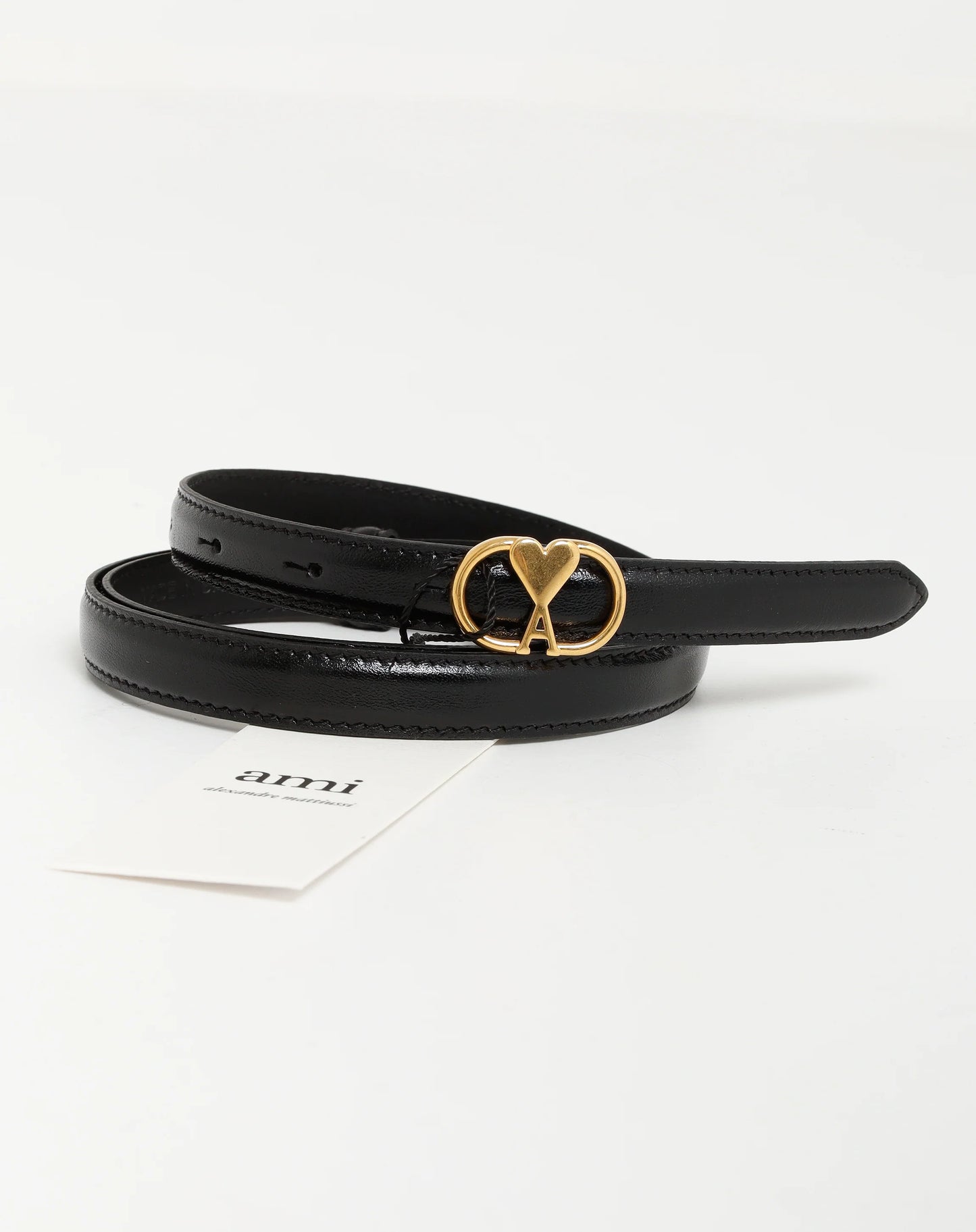 Black belt with gold buckle on a white background