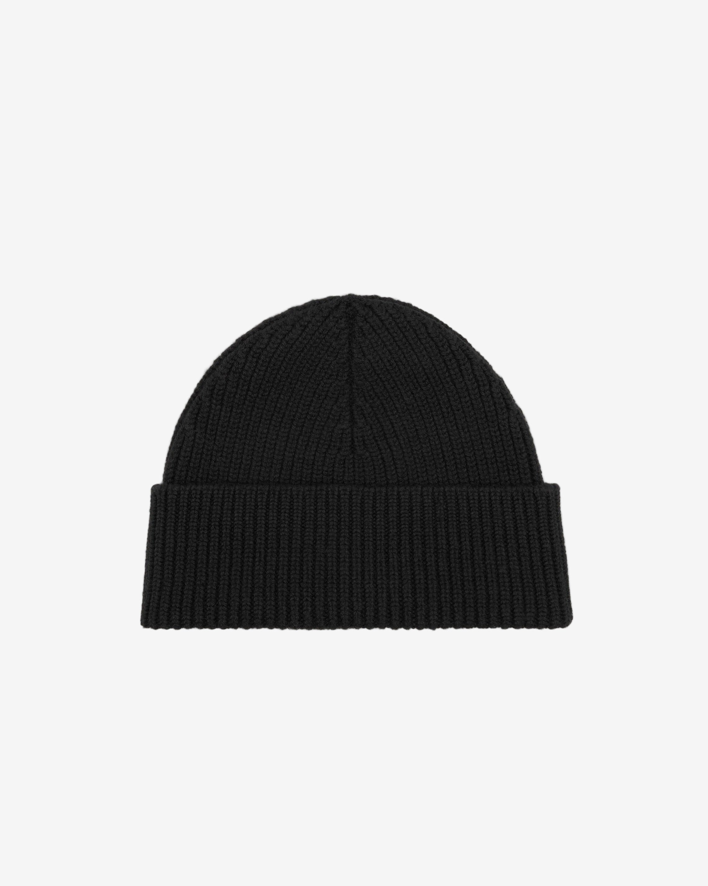 Black beanie hat on a light beige background