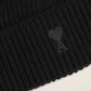 Black beanie hat on a light beige background