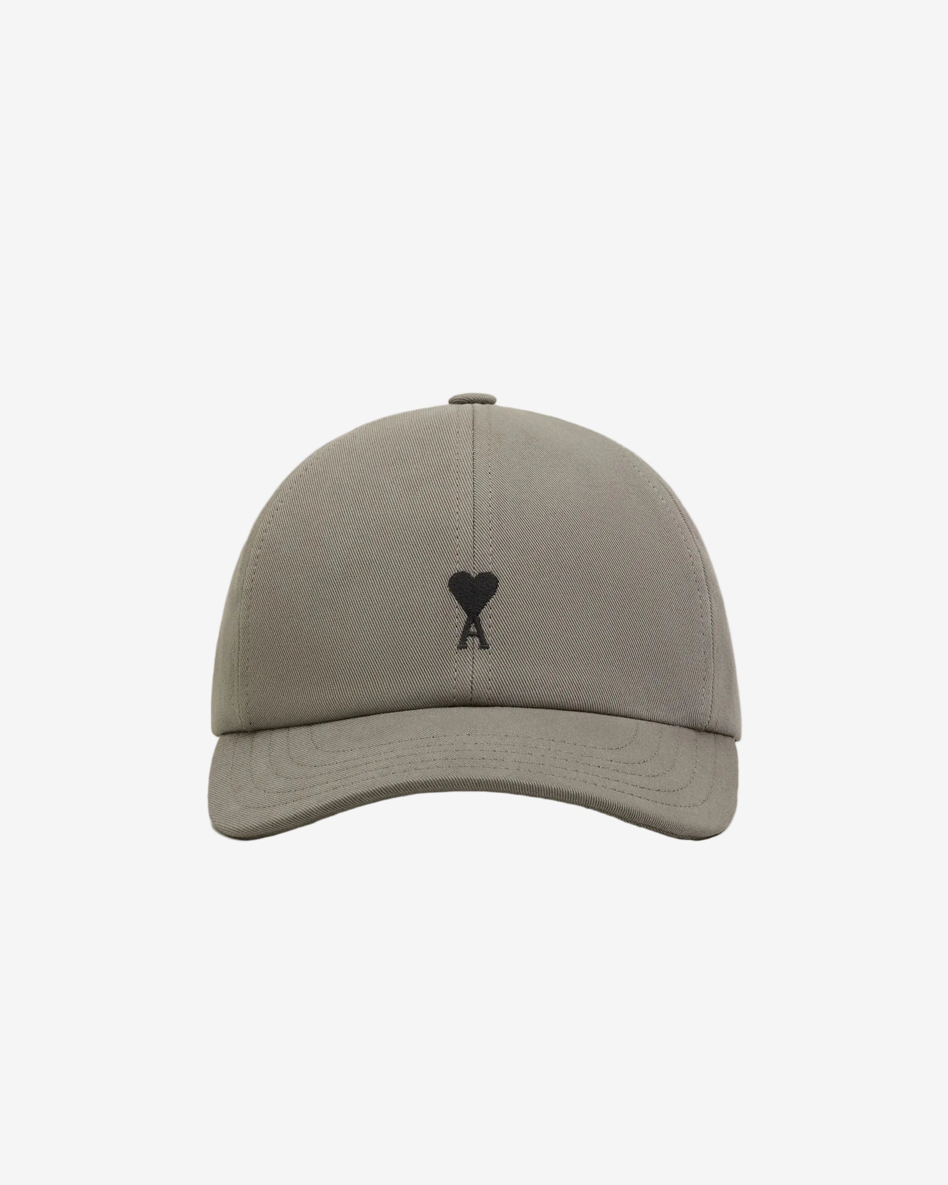 Gray cap with a black logo on a beige background ami paris