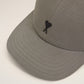 Gray cap with a black logo on a beige background ami paris