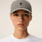 Gray cap with a black logo on a beige background ami paris