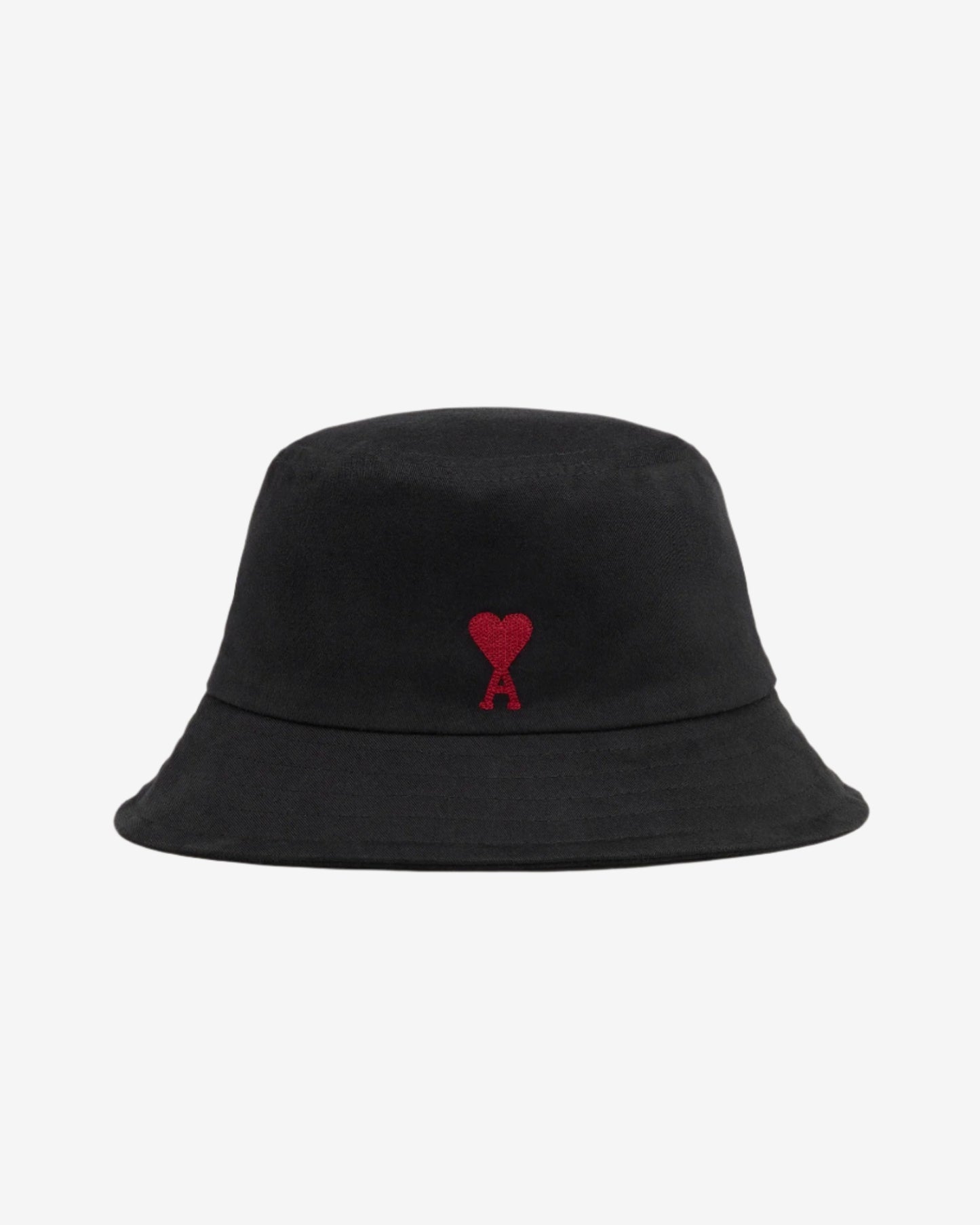 Black bucket hat with a red heart logo on a light beige background