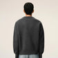 Dark gray cardigan with a red heart emblem on a beige background ami paris