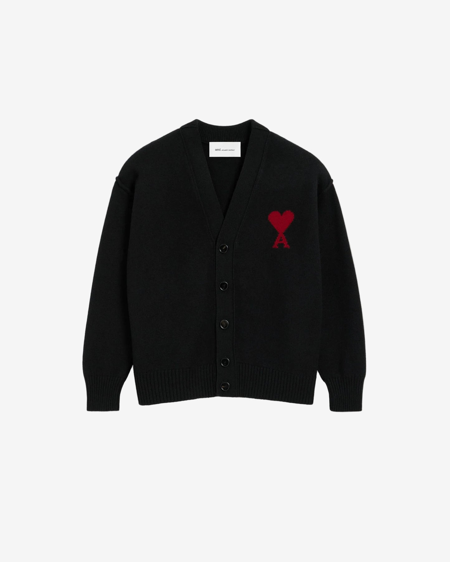 Black cardigan with a red heart emblem on a beige background ami paris
