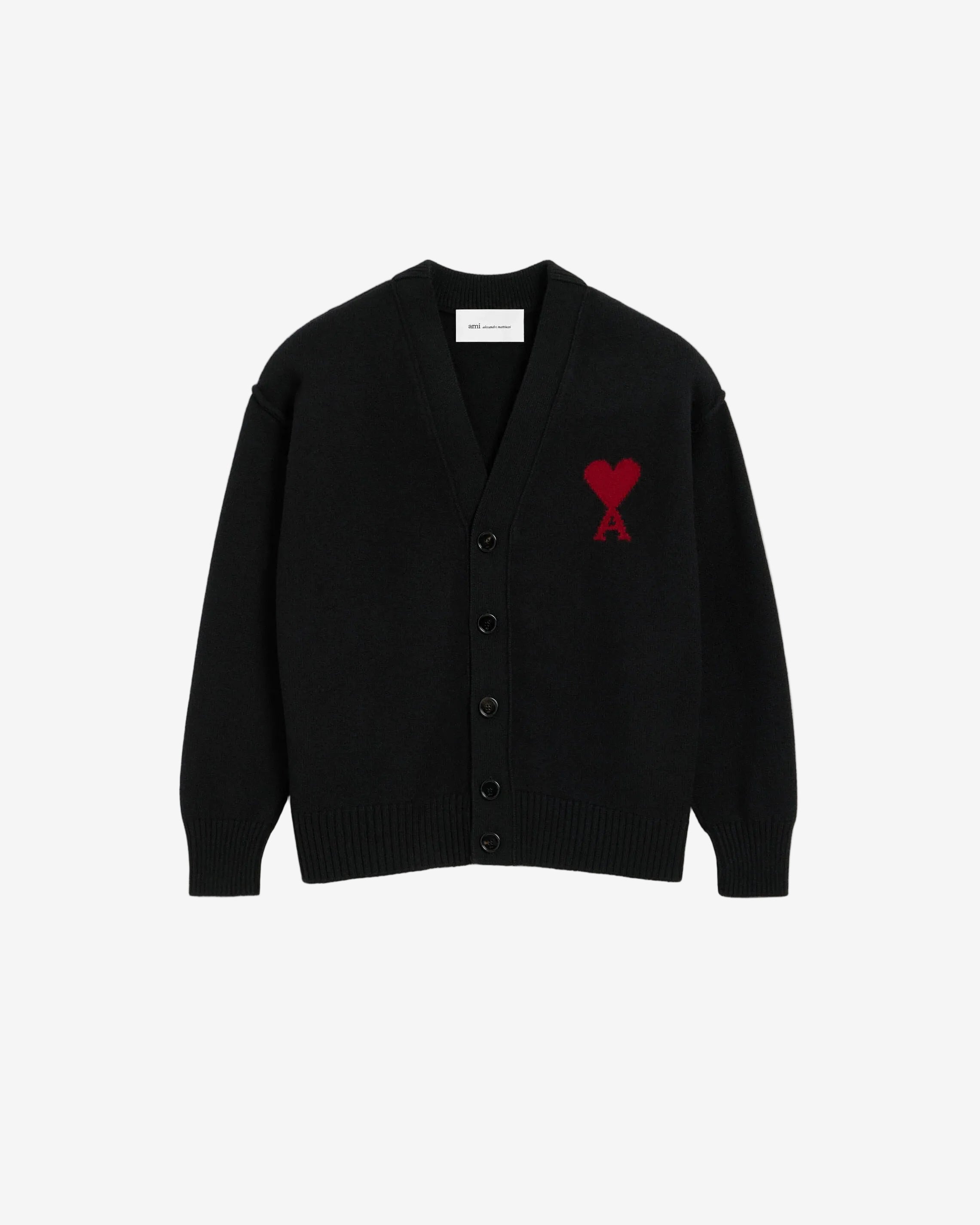 Black cardigan with a red heart emblem on a beige background ami paris