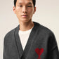 Dark gray cardigan with a red heart emblem on a beige background ami paris
