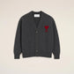 Dark gray cardigan with a red heart emblem on a beige background ami paris