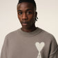Brown sweater with a logo on a beige background
