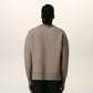Brown sweater with a logo on a beige background