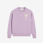 Lavender sweater with a heart design on a light beige background
