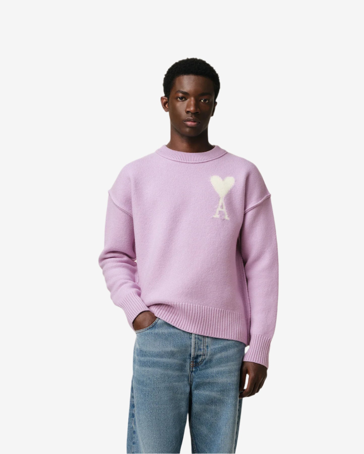 Lavender sweater with a heart design on a light beige background