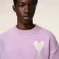 Lavender sweater with a heart design on a light beige background
