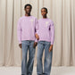 Lavender sweater with a heart design on a light beige background