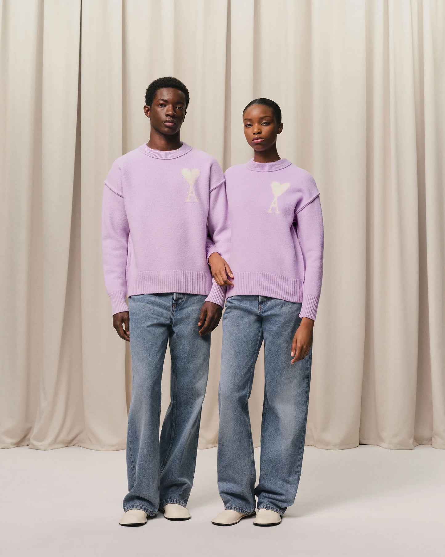 Lavender sweater with a heart design on a light beige background