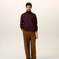 Maroon turtleneck sweater on a beige background