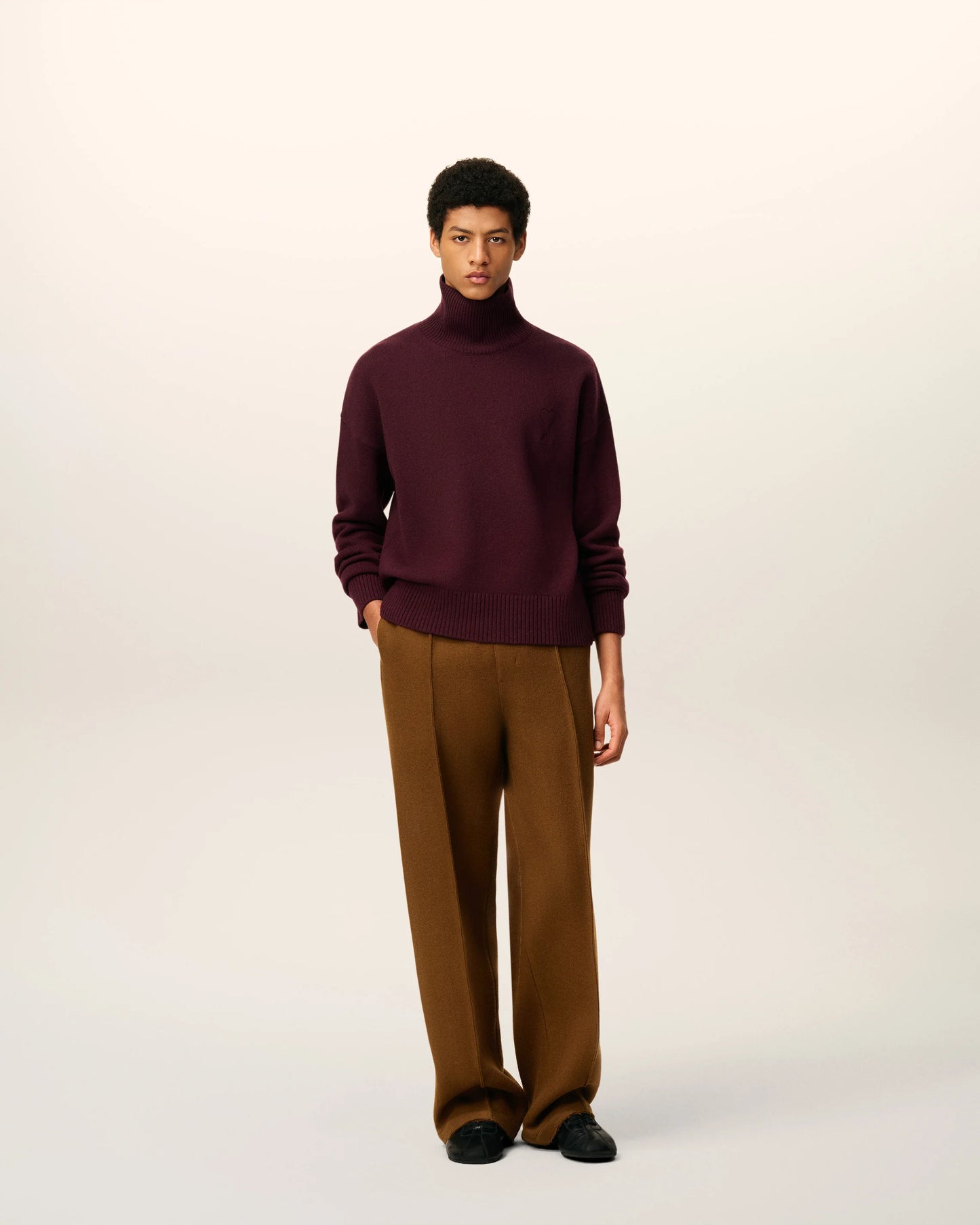 Maroon turtleneck sweater on a beige background
