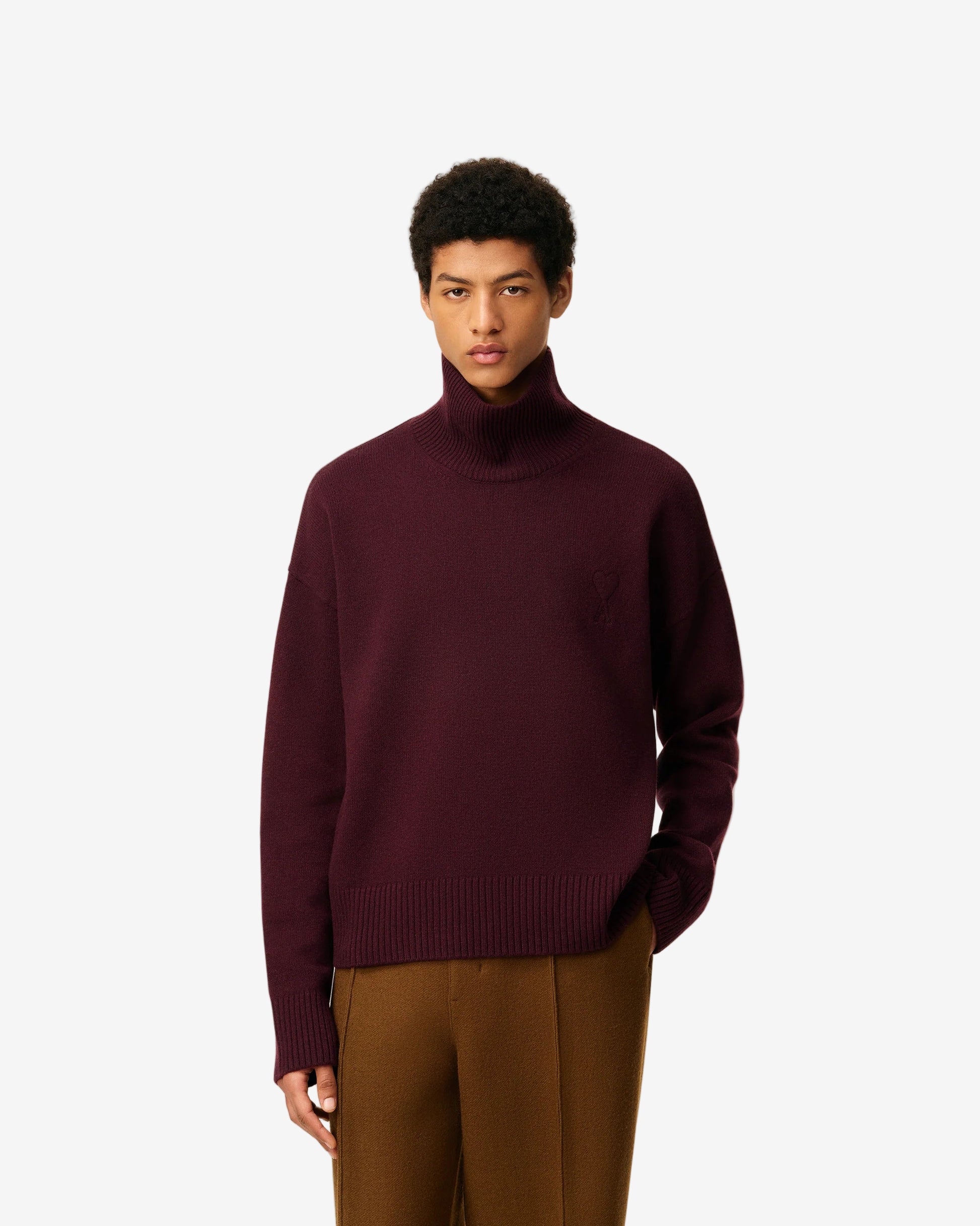 Maroon turtleneck sweater on a beige background