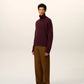 Maroon turtleneck sweater on a beige background