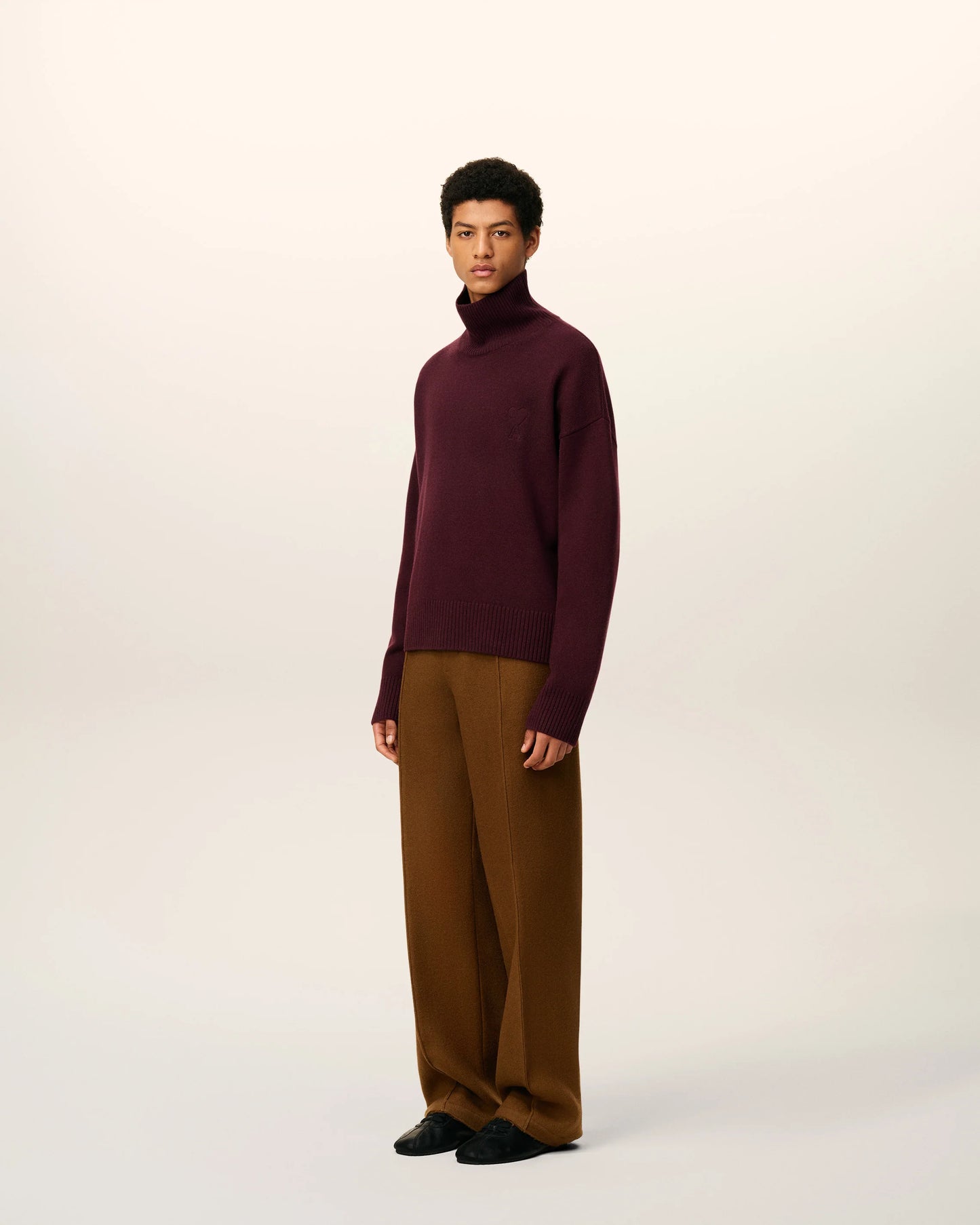 Maroon turtleneck sweater on a beige background