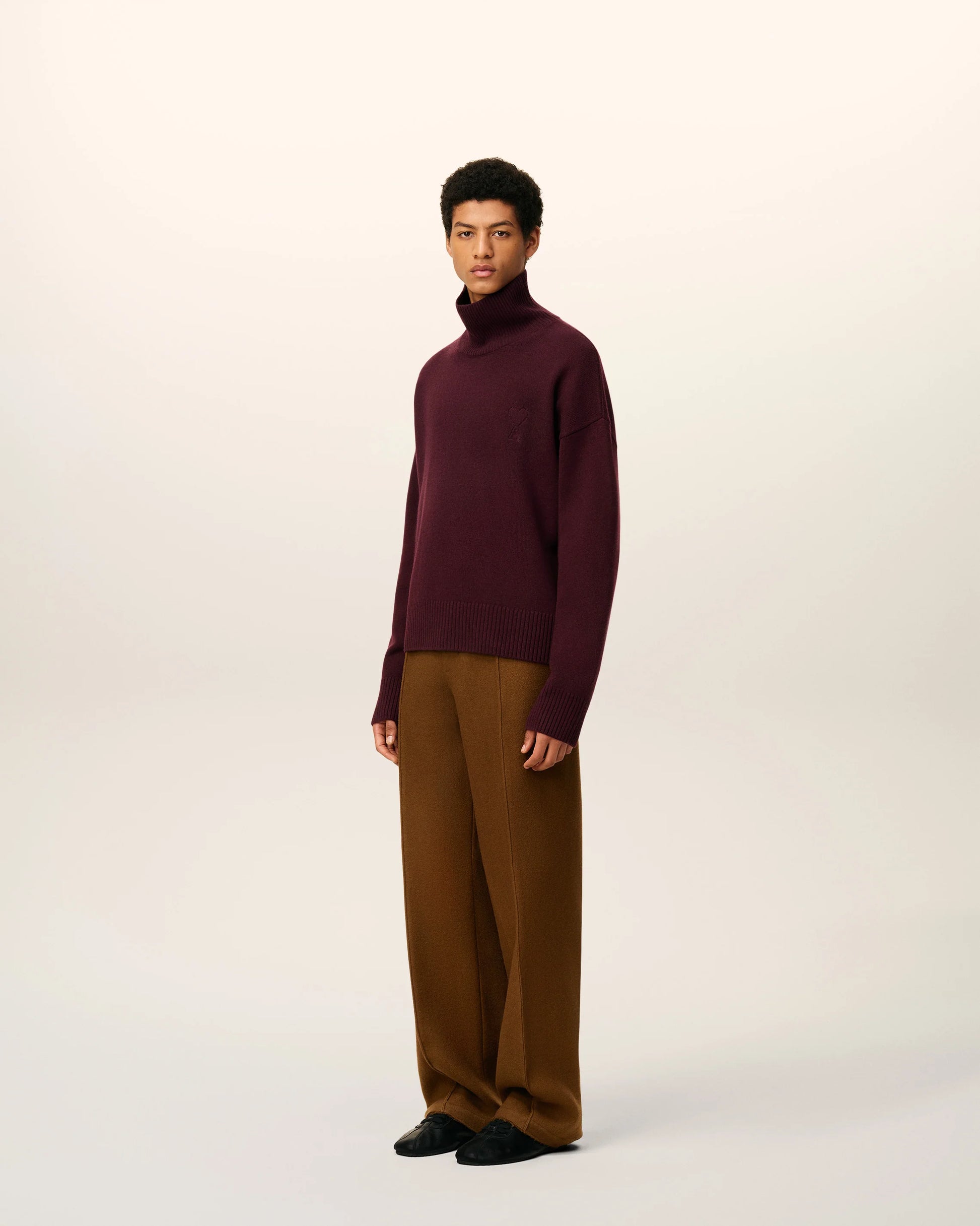 Maroon turtleneck sweater on a beige background