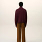 Maroon turtleneck sweater on a beige background