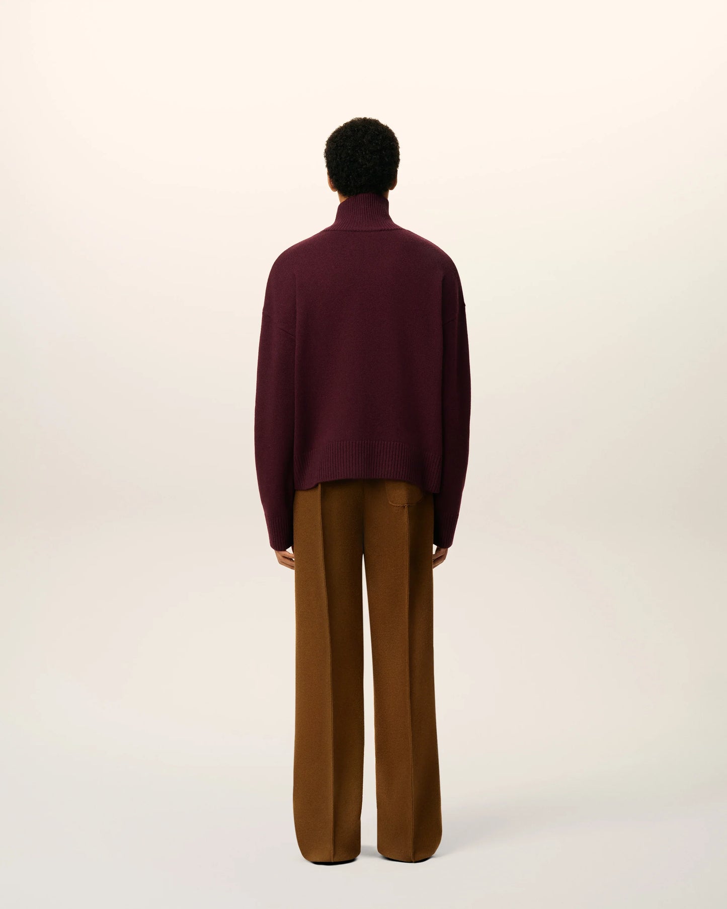 Maroon turtleneck sweater on a beige background