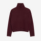 Maroon turtleneck sweater on a beige background