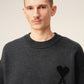 Gray sweater with a black heart and letter 'A' design on a beige background
