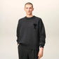 Gray sweater with a black heart and letter 'A' design on a beige background