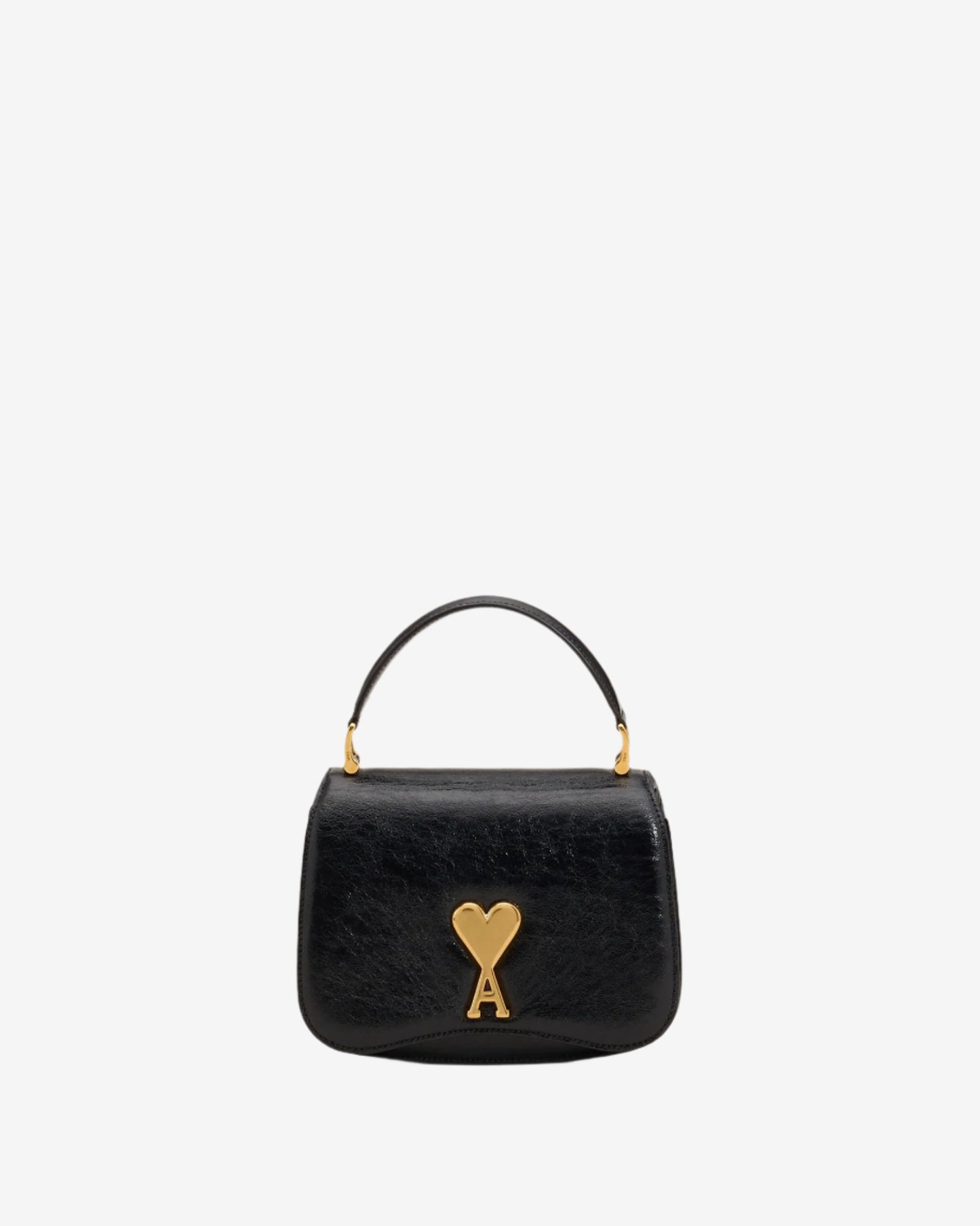 Black handbag with a gold heart and arrow design on a beige background