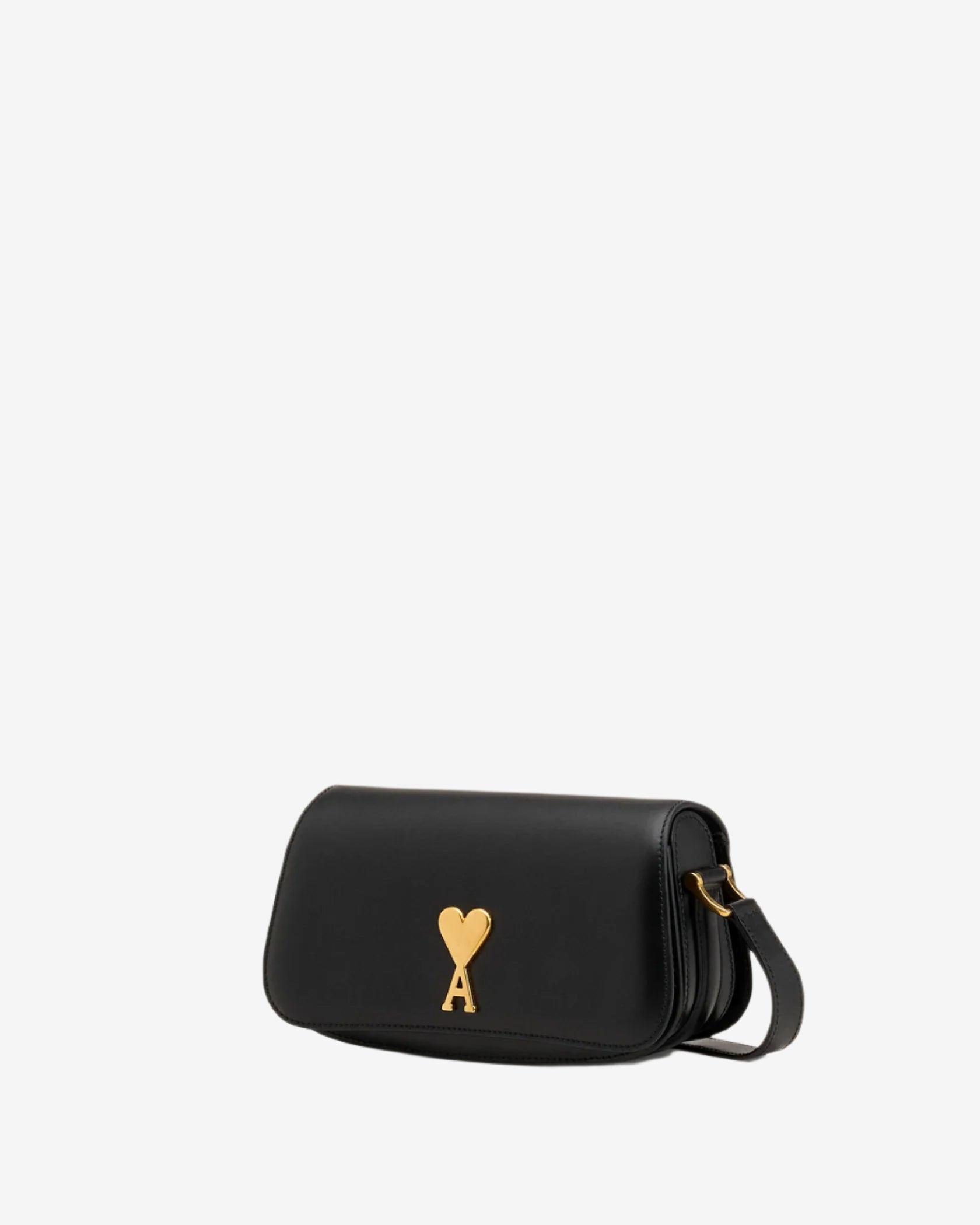 Black handbag with a gold heart emblem on a beige background