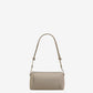 Light gray handbag with a heart detail on a light beige background ami paris